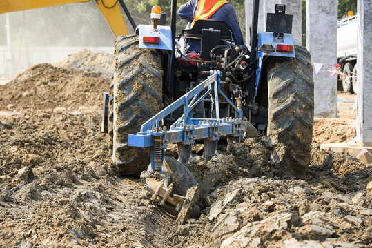 Soil improvment or soil cement mixing with water by tractors plowing for construction basement at construction site factory project