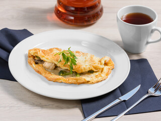Breakfast of scrambled eggs with mushrooms (omelette) is on a white plate. Concept healthy food.