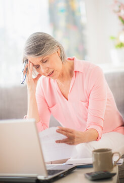 Portrait of uncertain woman doing paperwork