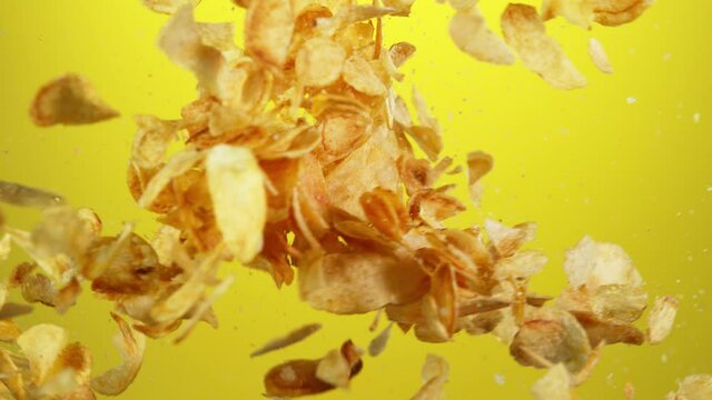 Super slow motion of flying fried potatoes chips hitting up in the air. Filmed on high speed cinema camera, 1000 fps.