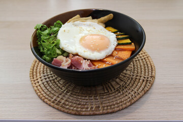 Fried bacon, fried egg and vegetable with rice.