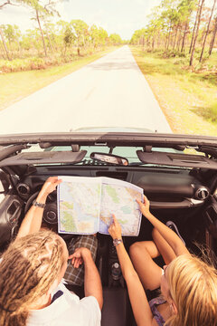 Couple checking map while driving