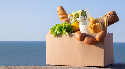 Fresh groceries in cardboard box. Food delivery concept