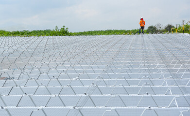 Construction worker wearing safety harness and safety uniform working at height instrallation...