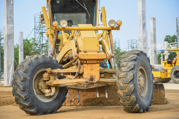 Fototapeta premium Motor Graders working grading leveling landfill on the road construction at the construction site project