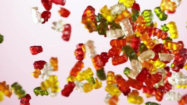 Super slow motion of flying gummy bears up in the air. Filmed on high speed cinema camera, 1000 fps.