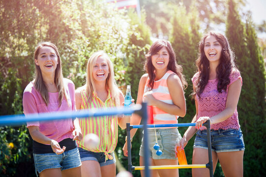 Portrait of young women throwing balls