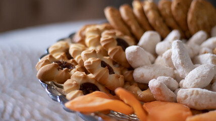 Sweet cookies in a glass vase, close-up. Blurred background.