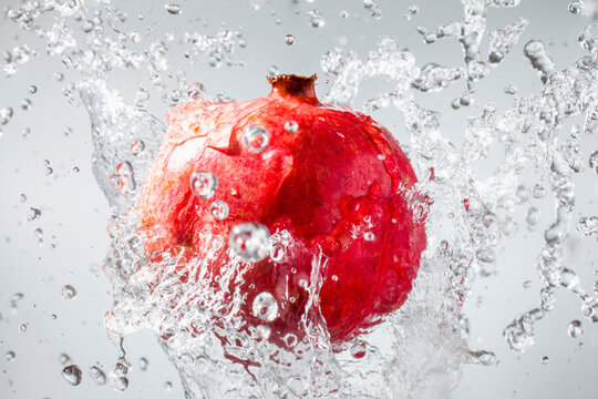 Droplets splashing on pomegranate