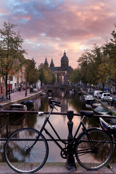 Basilica of st nicholas and bicycle by canal in city