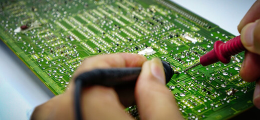 Electronics repair with tester.Repair technician test On an electronic board.	