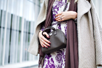 Close up fashion details, taupe trendy colors, woman wearing elegant coat, floral maxi dress,...