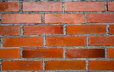 Weathered stained old brick wall background. The old wall was built of orange-red mud bricks with a...