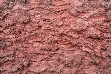 Red dry grungy clay tennis background texture.