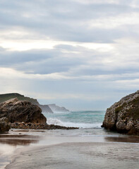 Fototapeta na wymiar beautiful wild rock beach vertical landscape