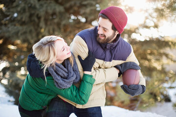 Couple playing American football