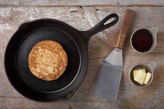 Directly Above View Of Kitchen Utensils And Pancake On Rustic Wooden Table