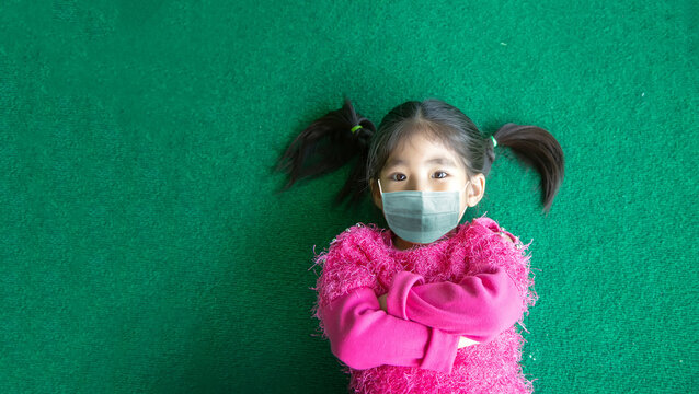 Happy Asian Kids Wearing Mask On Green