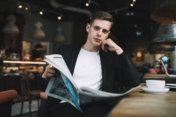 Pensive man with newspaper in cafe