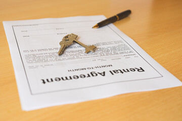 Rental agreement document with pencil and keys.