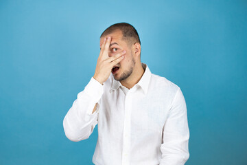 Russian business man wearing white shirt standing over blue background with sad and fear expression. Embarrassed and negative concept.