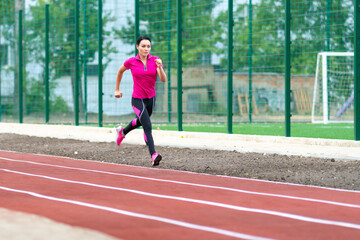 Obraz premium Fit healthy woman training on a race track