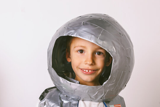 Portrait of young little boy wearing handmade astronaut uniform.