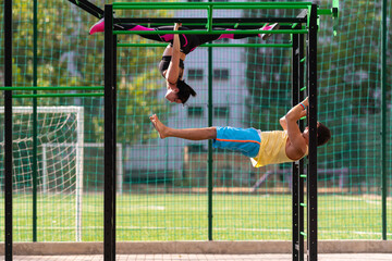 Young couple working out on parallel bars