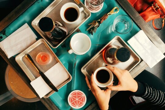 a cafe table full of coffee and mugs