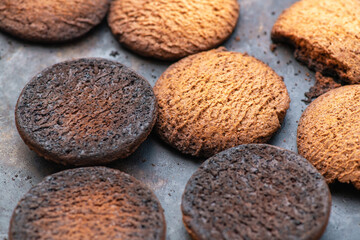 Fototapeta na wymiar Burnt cookies. Burnt, burnt oatmeal cookies lie on a black baking sheet.
