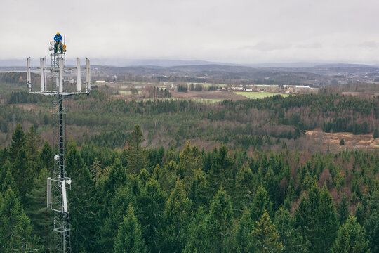 Working at heights, technician climbs up on a communications tower