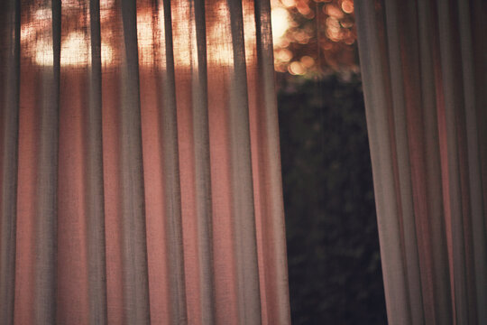 The end of a sunset casts an orange glow inside the house.