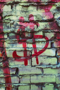 Money symbol spray painted on building wall