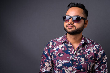 Fototapeta premium Young bearded Indian man against gray background