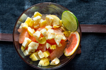 Delicious fruit salad in a glass bowl with grapefruit and guavas for breakfast