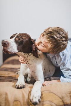 Young boy playing with his dog