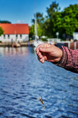 Scene while fishing on a river in Germany with a bait held up.