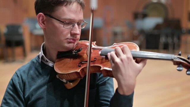 violinist playing the violin in the string quartet, close up