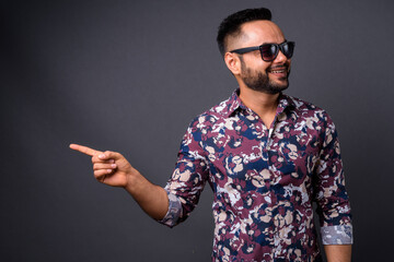 Fototapeta premium Young bearded Indian man against gray background