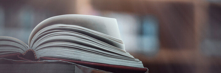 Book stack in the library and blurred bookshelf background for education. education background. back to school concept.