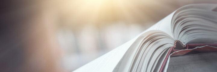 Book stack in the library and blurred bookshelf background for education. education background....