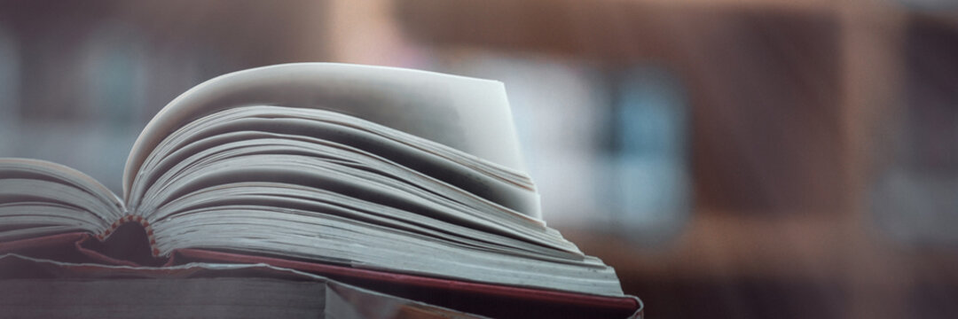 Book stack in the library and blurred bookshelf background for education. education background. back to school concept.