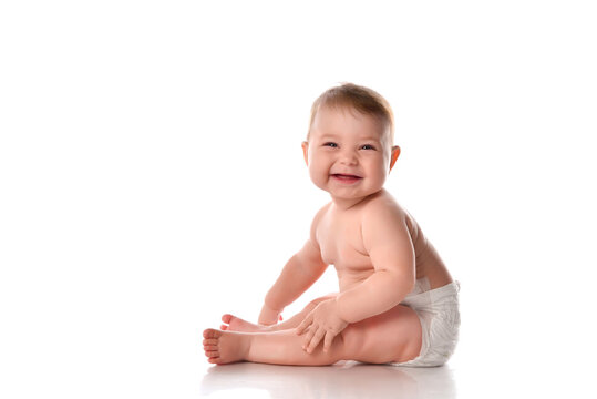 Smiling baby sitting on floor over white copyspace