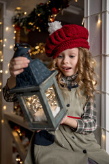 little girl admires the garland she holds in her hands