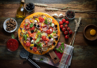 
Ingredients for making homemade pizza on a wooden table