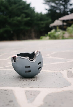 sport safety helment upturned on a driveway