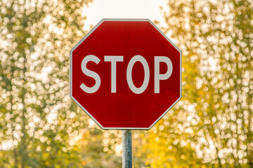 Red stop sign on a nature background