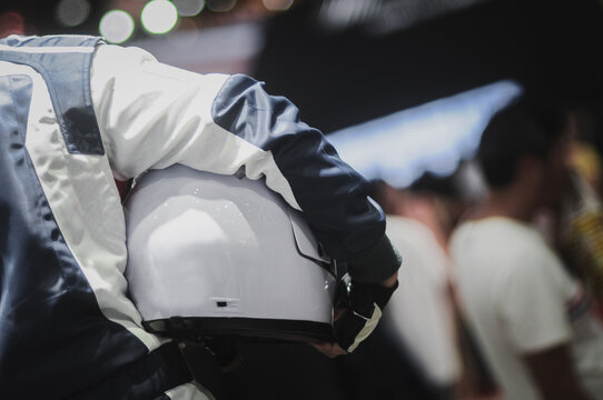Racers hold helmets In the award ceremony. Selective focus.
