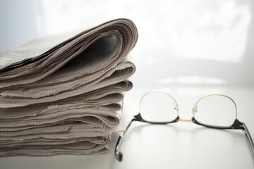 stack of newspapers and glasses