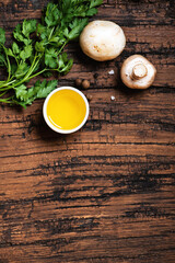 Food background on a dark brown wooden table. Herbs and spices on an old wooden table top view. Free space for text. Cooking ingredients, copy space.